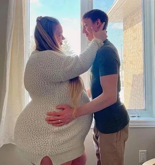 A happy couple, Matt and Brittany Montgomery, embracing each other and smiling at the camera.