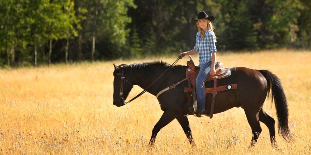 Amy Fleming riding Spartan through the picturesque Heartland Ranch.