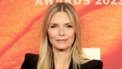 Michelle Pfeiffer smiling at a red carpet event.