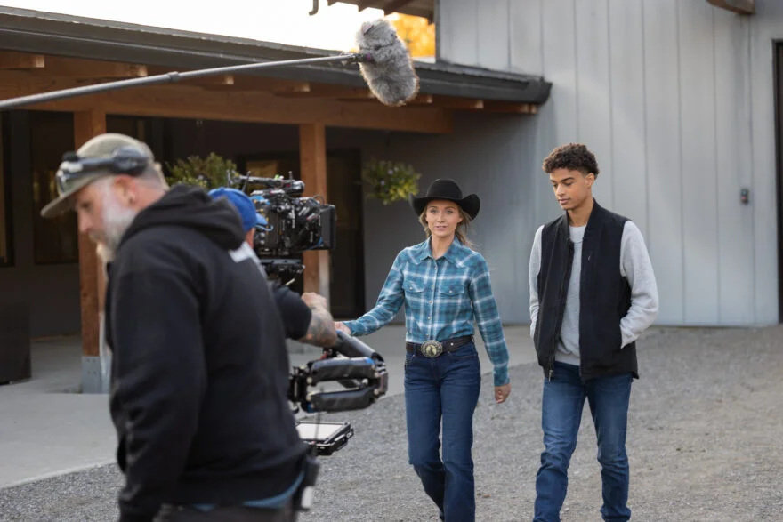 Heartland season 16 cast photo, featuring Amber Marshall and other cast members on a ranch setting