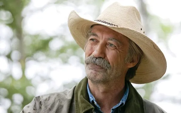 Shaun Johnston as Jack Bartlett, leaning on a fence post with a cowboy hat and typical rancher attire